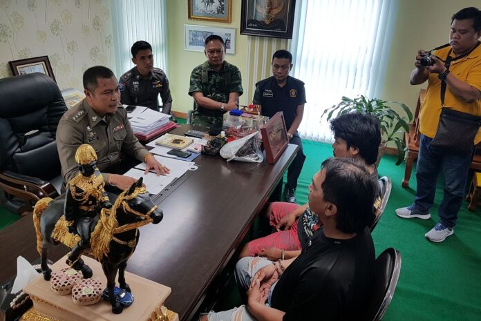 Surasak Intarachote, 50, and Rattanapol Sae-ui, 21, talk to Col. Apichai Klobpetch on Tuesday
