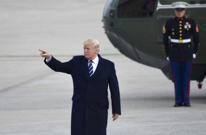 President Donald Trump gestures as he walks towards Air Force One at John F. Kennedy International Airport in New York, Saturday, Dec. 2, 2017. Trump spent the day in New York attending a trio of fundraisers. (Susan Walsh/Associated Press)