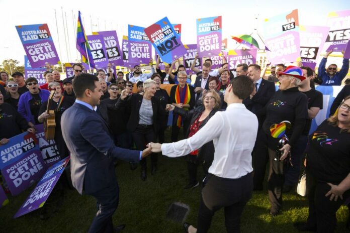 Same-sex marriage campaigners and volunteers cheer as they call on politicians to pass marriage equality legislation during rally outside Parliament House in Canberra, Australia, Thursday, Dec. 7, 2017. Gay marriage was endorsed by 62 percent of Australian voters who responded to a government-commissioned postal ballot by last month. Photo: Lukas Coch / AAP Image via AP