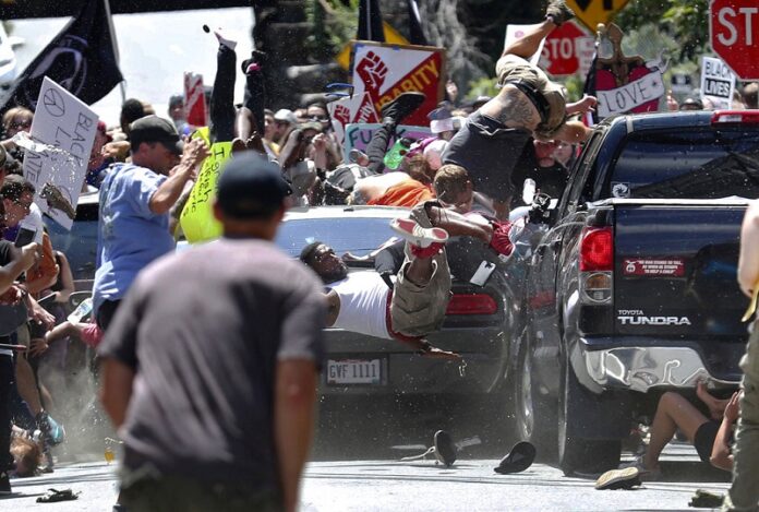 People are thrown into the air as a car drives into a group of protesters demonstrating against a white nationalist rally in August in Charlottesville, Virginia. Photo: Associated Press