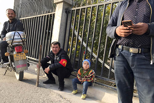 Residents act as neighborhood watch for suspicious activities in a village near Korla in western China's Xinjiang region. Photo: Ng Han Guan / Associated Press