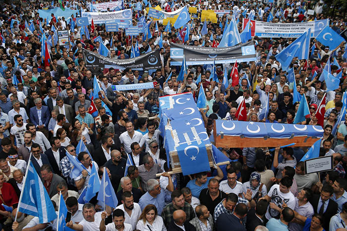 Uighurs living in Turkey and their supporters, some carrying coffins representing Uighurs who died in China's far-western Xinjiang region, chant slogans July 4, 2015, at a protest in Istanbul against what they call China's oppression of Muslim Uighurs. Photo: Emrah Gurel / Associated Press