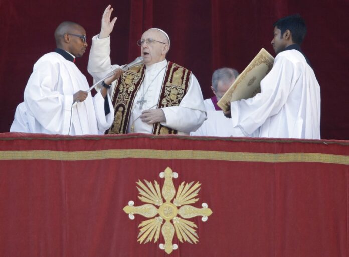 Pope Francis delivers the Urbi et Orbi (Latin for ' to the city and to the world') Christmas' day blessing from the main balcony of St. Peter's Basilica on Monday at the Vatican. Photo: Alessandra Tarantino / Associated Press