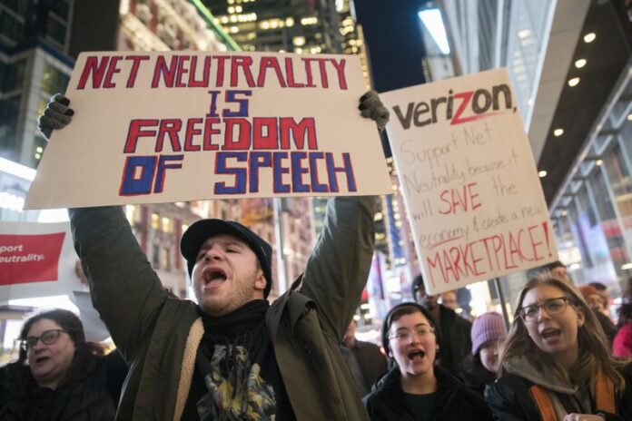 FILE - In this Thursday, Dec. 7, 2017, file photo, demonstrators rally in support of net neutrality outside a Verizon store in New York. The Federal Communications Commission is voting Thursday, Dec. 14 to undo Obama-era “net neutrality” rules that guaranteed equal access to the internet. Photo: Mary Altaffer / Associated Press