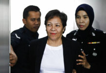 Malaysia Acquits Aussie Woman of Drug Trafficking Australian Maria Elvira Pinto Exposto, at center, is escorted by a police officer at a court hearing Wednesday at Shah Alam High Court in Shah Alam, Malaysia. Photo: Sadiq Asyraf / Associated Press