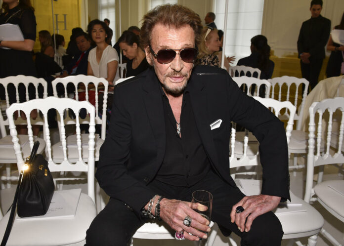 French rock singer Johnny Hallyday waits July 6, 2016, before Christian Dior's Haute Couture Fall-Winter 2016-2017 fashion collection presented in Paris, France. Photo: Zacharie Scheurer / Associated Press