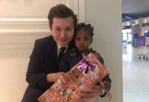 Opinion: A Happy Christmas and New Year Every Day? No Thanks Airport official Kanaruj Artt Pornspolt poses in 2017 with a Christmas present for a child identified as Mashia who had been living with her family for three months inside Suvarnabhumi Airport. Photo: Kanaruj Artt Pornspolt / Facebook