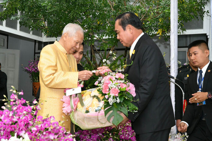 Prem Tinsulanonda, chairman of the king's Privy Council at left, receives a gift basket from junta leader Prayuth Chan-ocha, who serves as prime minister.