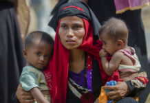 Rights Group Details Lead-Up to Myanmar Attacks on Rohingya Rohingya Muslim woman, Rukaya Begum, who crossed over from Myanmar into Bangladesh, holds her son Mahbubur Rehman, at left, and her daughter Rehana Bibi, on Oct. 22, 2017, after the government moved them to newly allocated refugee camp areas, near Kutupalong, Bangladesh. Photo: Dar Yasin / Associated Press