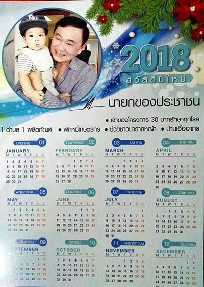 A 2018 calendar showing fugitive former Prime Minister Thaksin Shinawatra holding one of his twin granddaughters.