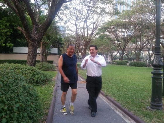 Former Bangkok Gov. Sukhumbhand Paribatra, at left, walks with Chuvit Kamolvisit in Chuvit Garden in an undated file photo. Photo: Matichon