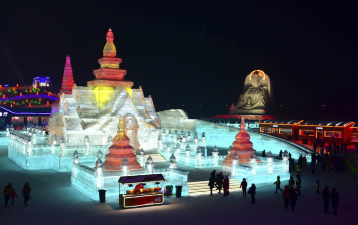 Visitors walk among the attractions on Jan. 2 at the Harbin International Ice and Snow Festival in Harbin in northeastern China's Heilongjiang Province. Photo: Chinatopix