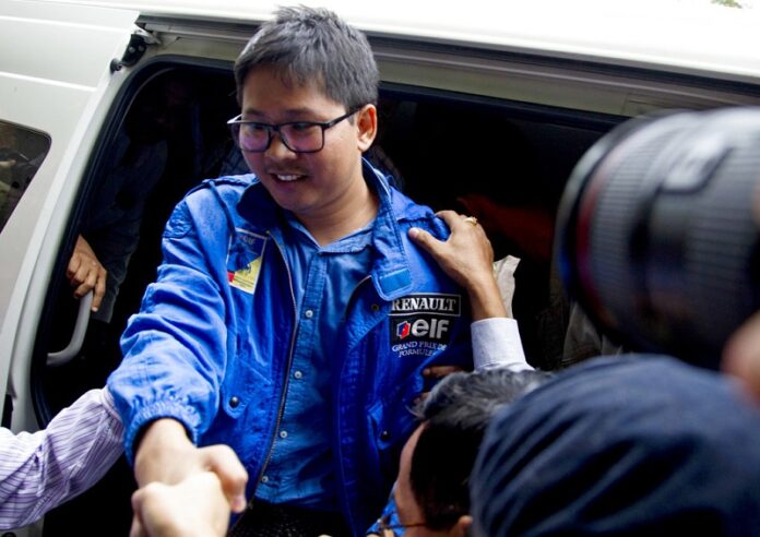 Reuters journalist Thet Oo Maung, known as Wa Lone, exits a police van as he arrives for a court appearance last December outside Yangon, Myanmar. Photo: Thein Zaw / Associated Press