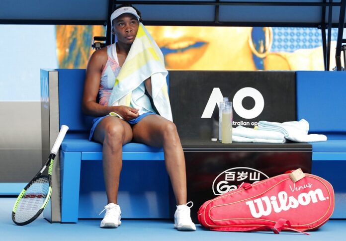 United States' Venus Williams dries her face off with a towel during a break while playing Switzerland's Belinda Bencic in their first round match at the Australian Open tennis championships Monday in Melbourne, Australia. Photo: Vincent Thian / Associated Press