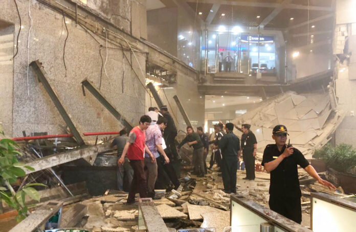 Indonesian security stand near the ruin of a structure inside the Jakarta Stock Exchange tower Monday in Jakarta, Indonesia. Photo: Associated Press