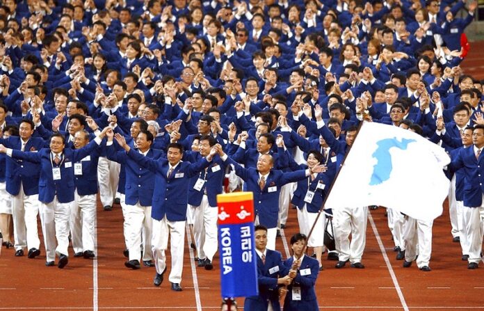 Athletes from North and South Korea march together in 2002 led by a unification flag, during an opening ceremony for the 14th Asian Games in Busan, South Korea. Photo: Associated Press