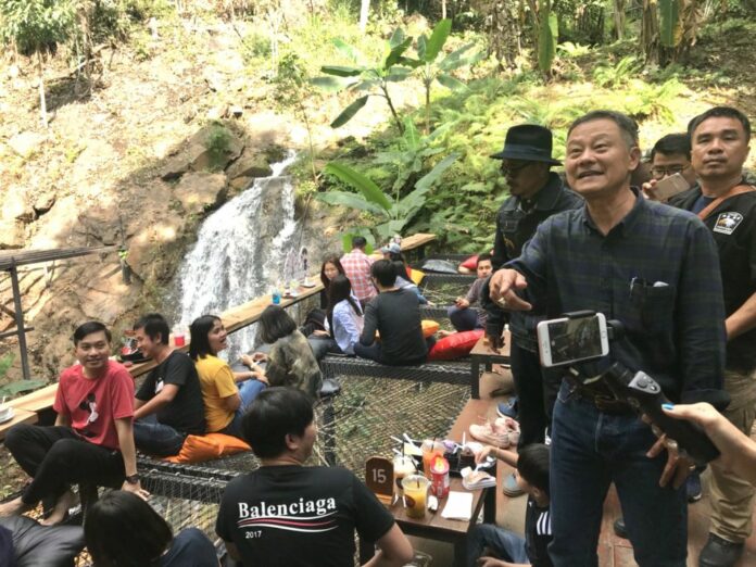 Mae Rim district chief Chaisang Pattanasakpinyo, second from right, points as he inspects the Jungle de Cafe on Tuesday in Chiang Mai province.