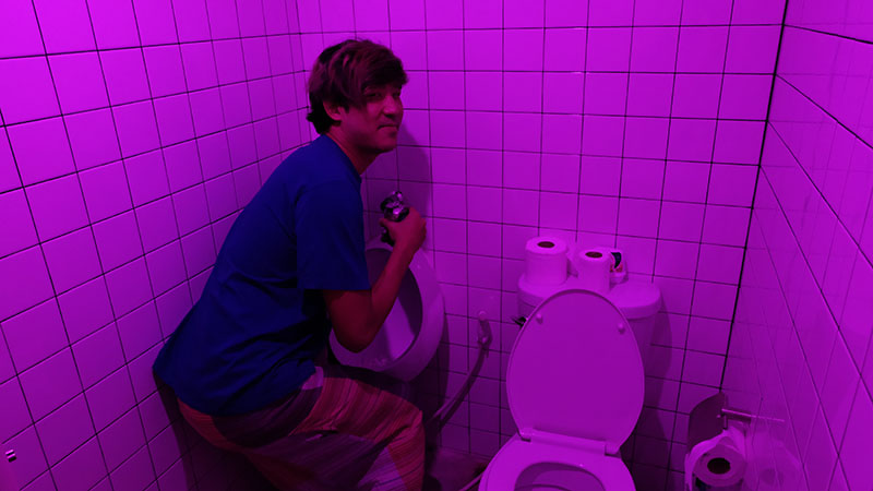 Taopiphop Limjittrakorn, or Tao, invites a reporter to take his photo next to a urinal.