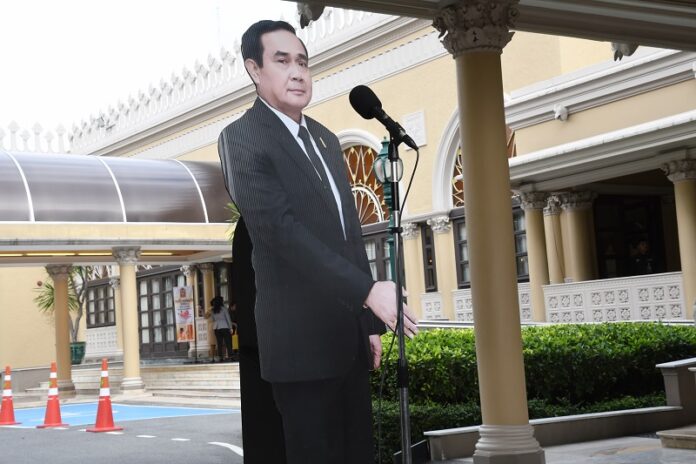 A cardboard figure of Prime Minister Gen. Prayuth Chan-ocha erected before a microphone Monday in Bangkok.