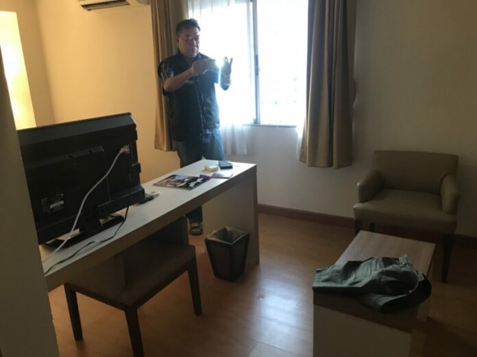 Police on Sunday take photos of the room where Hakan Lennart Karlberg was staying.