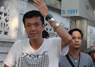 Ekachai Hongkangwan displays the watches worn on his wrist as a part of his protest today at the Government House in Bangkok.