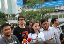 Junta Orders Pro-Democracy Leaders Charged With Inciting Rebellion From left, an unidentified protest photographer, Rangsiman Rome, Nutta Mahattana and Sirawit Seritiwat at a January protest on the Skywalk at Pathumwan intersection in Bangkok.