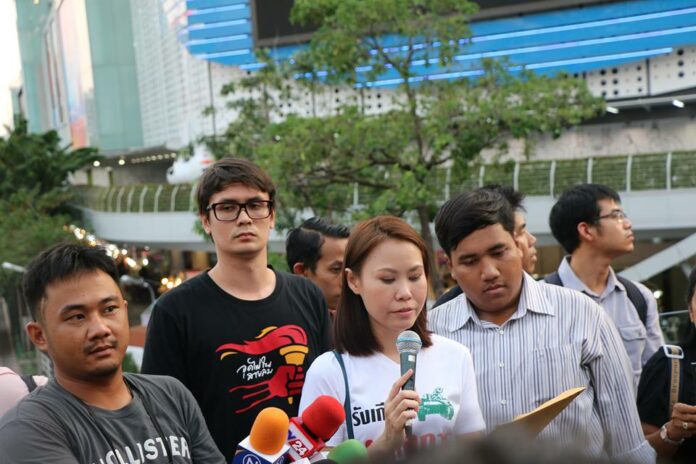 From left, an unidentified protest photographer, Rangsiman Rome, Nutta Mahattana and Sirawit Seritiwat at a January protest on the Skywalk at Pathumwan intersection in Bangkok.