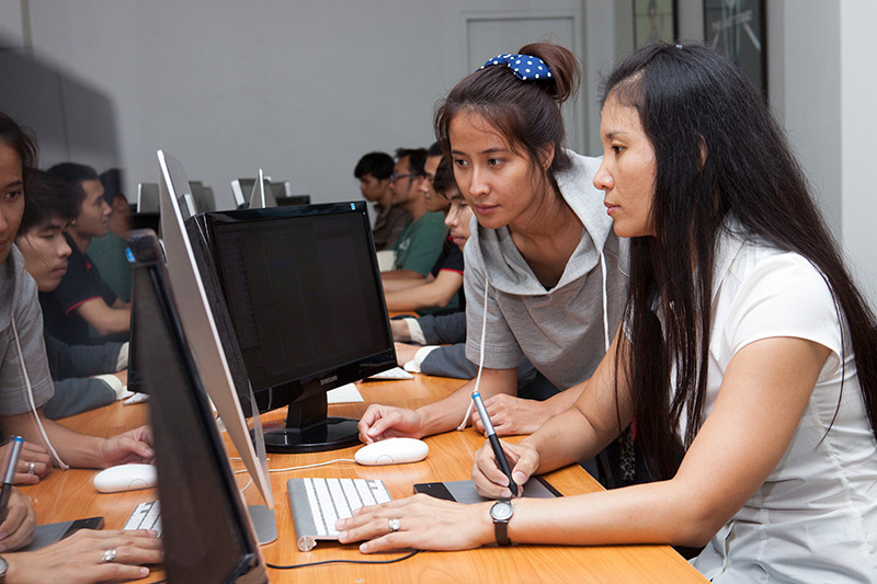 Mayura Sinlee Seagrave, at right, trains a Thai worker at multi-national company Ultrafina. Photo: Michele Zack