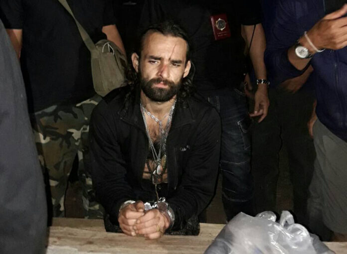 Amaury Rigaud in police custody Sunday night in Tak.