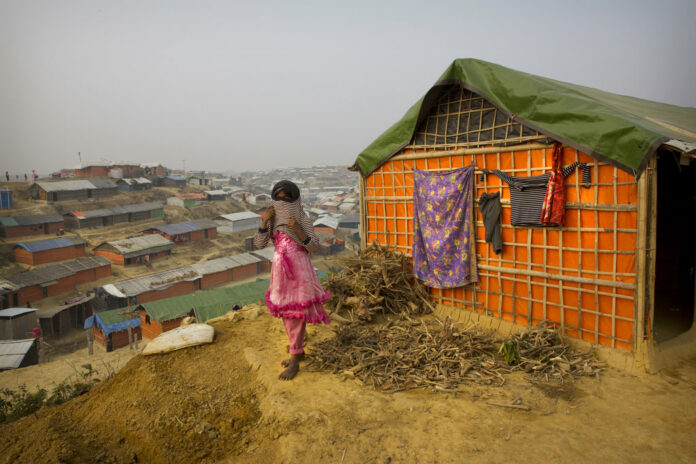 A Rohingya Muslim girl wears a sweater outside her tent Sunday in the Balukhali refugee camp 50 kilometers from Cox's Bazar, Bangladesh. Photo: Manish Swarup / Associated Press