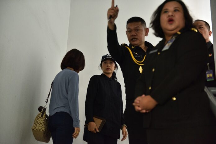 An army officer gestures at reporters Tuesday as family members of the late cadet Pakapong Tanyakan arrives to hear the investigation result