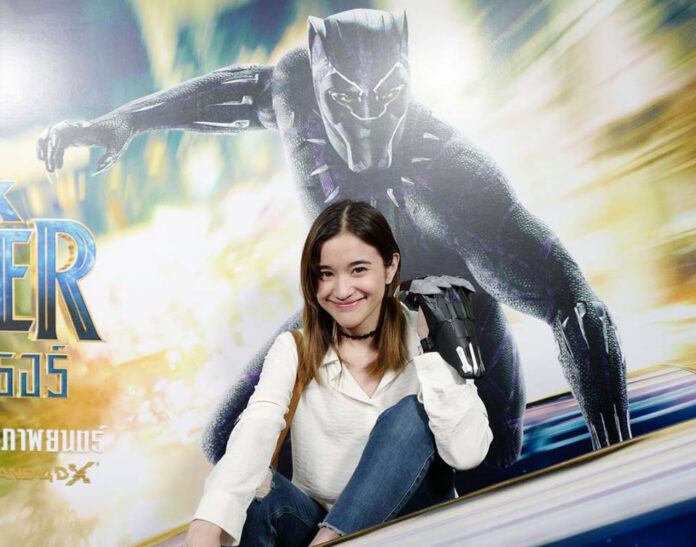 A Thai fan poses with a promotional display for “Black Panther.” Photo: Zom Marie / Facebook