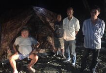 Attorney General to Seek 3 Million Baht From Premchai Premchai Karnasuta, far left, sits in the campsite where he was found on Feb. 5 with the remains of a leopard, panther and other wildlife in the Thungyai Naresuan Wildlife Sanctuary in Kanchanaburi province.