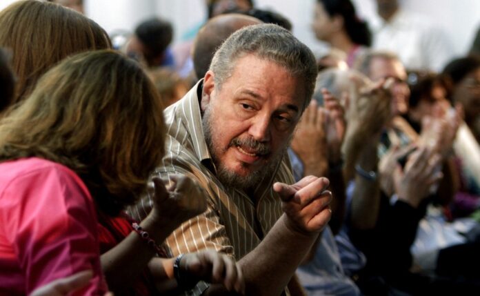 FILE - In this March 14, 2012 file photo, Fidel Castro Diaz-Balart, son of then Cuban leader Fidel Castro, speaks in 2012 with an unidentified woman during the presentation of his father's book