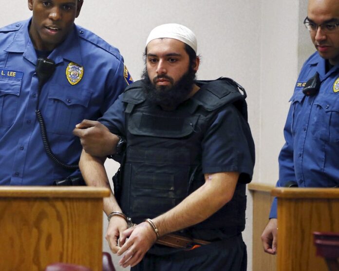 Dec. 20, 2016, Ahmad Khan Rahimi, center, is led into court in Elizabeth. Photo: Mel Evans
