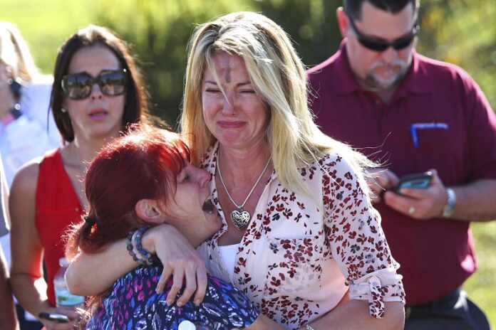 Parents wait for news after reports of a shooting at Marjory Stoneman Douglas High School, Wednesday in Parkland, Florida. Photo: Joel Auerbach / Associated Press