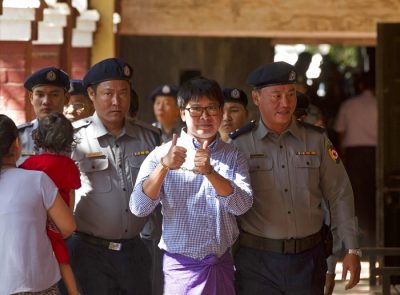 Reuters journalist Wa Lone gives a thumbs up as he is escorted by Myanmar police Photo: Thein Zaw / Associated Press