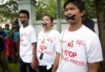 Myanmar Govt Under Suu Kyi Cracks Down on Journalists Myanmar journalist Wa Lone, right, stands with other journalists with their mouths taped to symbolize the government's crackdown on media in Yangon, Myanmar. Khin Maung Win / Associated Press