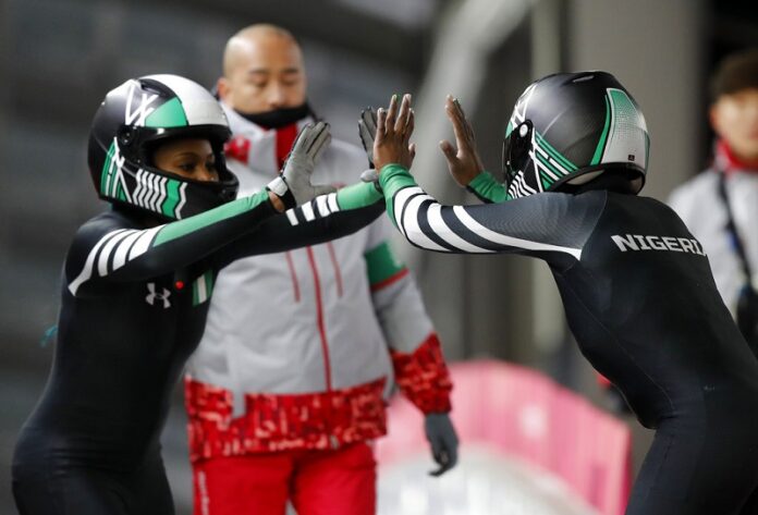 Driver Seun Adigun, right, and Akuoma Omeoga of Nigeria finish their second heat during the women's two-man bobsled competition at the 2018 Winter Olympics, Tuesday in Pyeongchang, South Korea. Photo: Andy Wong / Associated Press