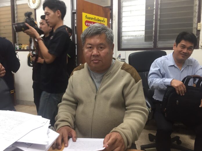 Premchai Karnasuta sits Tuesday at the local police station in Kanchanaburi