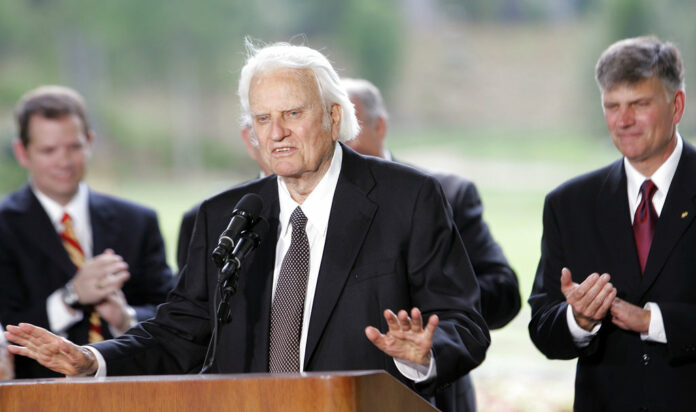 Billy Graham speaks in 2007 as his son Franklin Graham, right, listens during a dedication ceremony for the Billy Graham Library in Charlotte, North Carolina. Photo: Gerry Broome / Associated Press