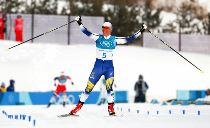 Charlotte Kalla of Sweden celebrates Saturday after winning the women's 7.5km /7.5km skiathlon cross-country skiing competition at the 2018 Winter Olympics in Pyeongchang, South Korea. Photo: Matthias Schrader / Associated Press