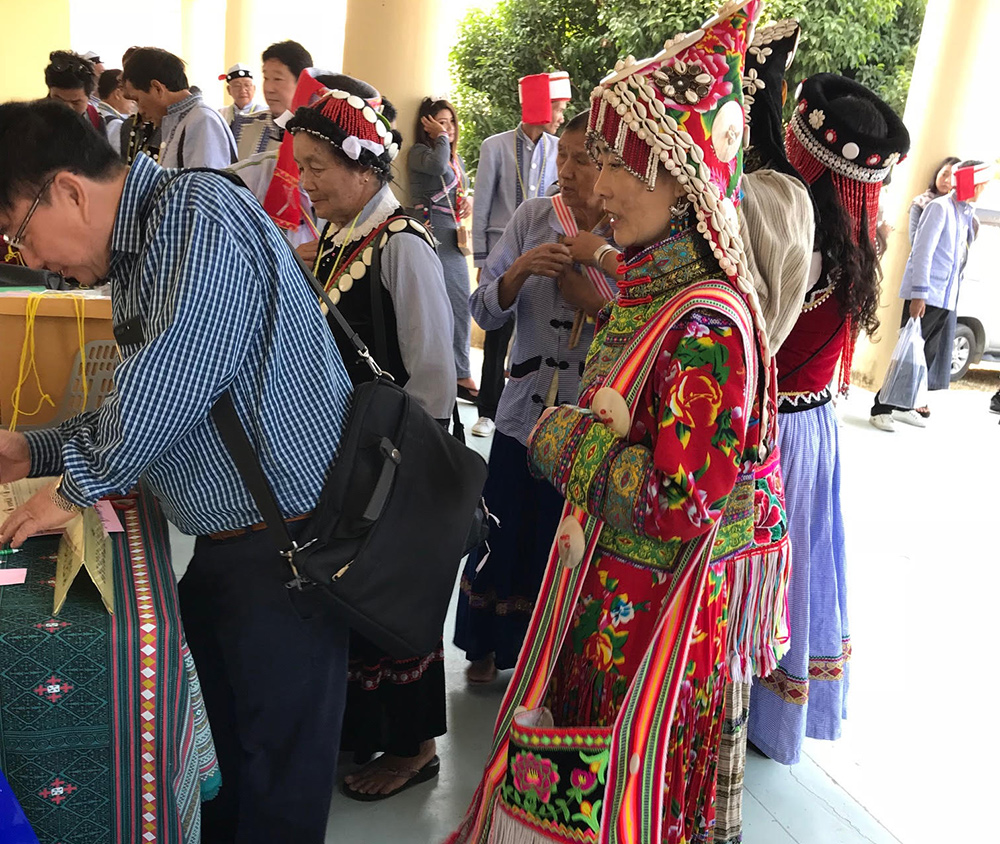 Attendees register at the 'Lisu Cultural Inheritance and Sustainable Development' on Friday in in Chiang Mai’s Mae Taeng district. Photo: Mark Goldschmidt