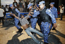 India, China Vie for Influence as Crisis Unfolds in Maldives Maldivian police officers on Feb. 2 detain an opposition protester demanding the release of political prisoners during a protest in Male, Maldives. Photo: Mohamed Sharuhaan / Associated Press