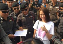 Court Frees MBK39 Leaders to Await Trial Pro-democracy activist Nuttaa Mahattana with police Thursday in Bangkok.