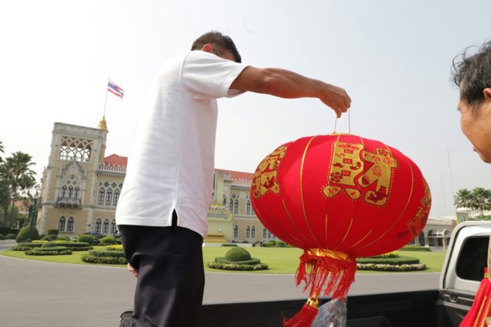 Government House staff decorate the building with Chinese red lanterns on Thursday