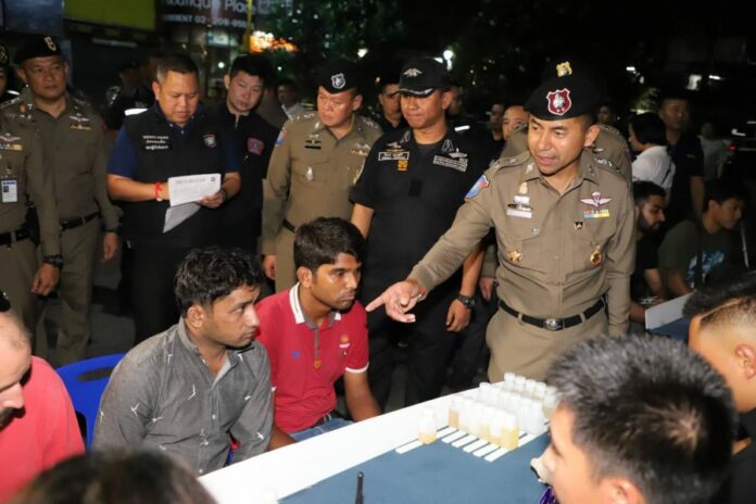 Police Deputy Commissioner Maj. Gen. Surachet Hakpal points some arrested foreigners.