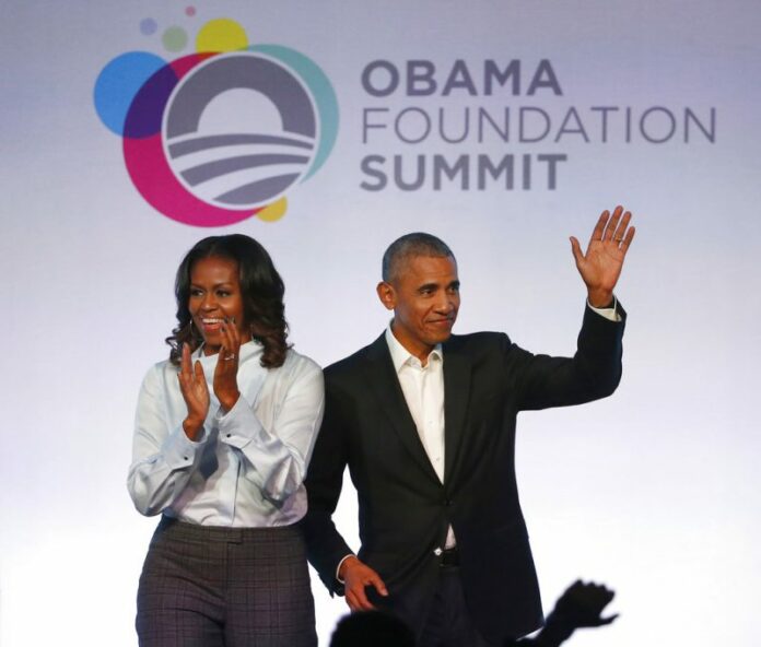 Former President Barack Obama and former first lady Michelle Obama arriving for the first session of the Obama Foundation Summit in Chicago. Photo: Charles Rex Arbogast / Associated Press