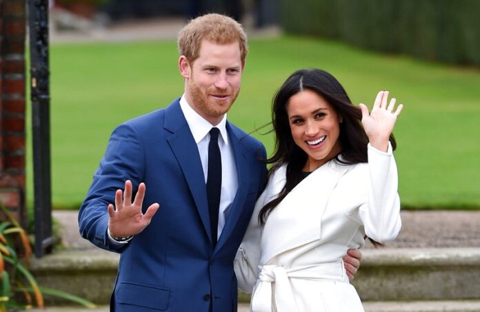 Prince Harry and Meghan Markle posing for the media at Kensington Palace in London. Photo: Eddie Mulholland / Associated Press