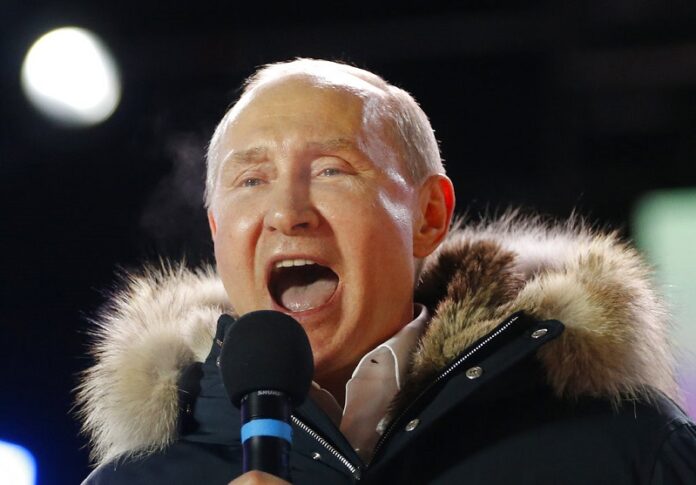 Russian President Vladimir Putin speaks to supporters during a rally near the Kremlin in Moscow on Sunday. Photo: Alexander Zemlianichenko / Associated Press